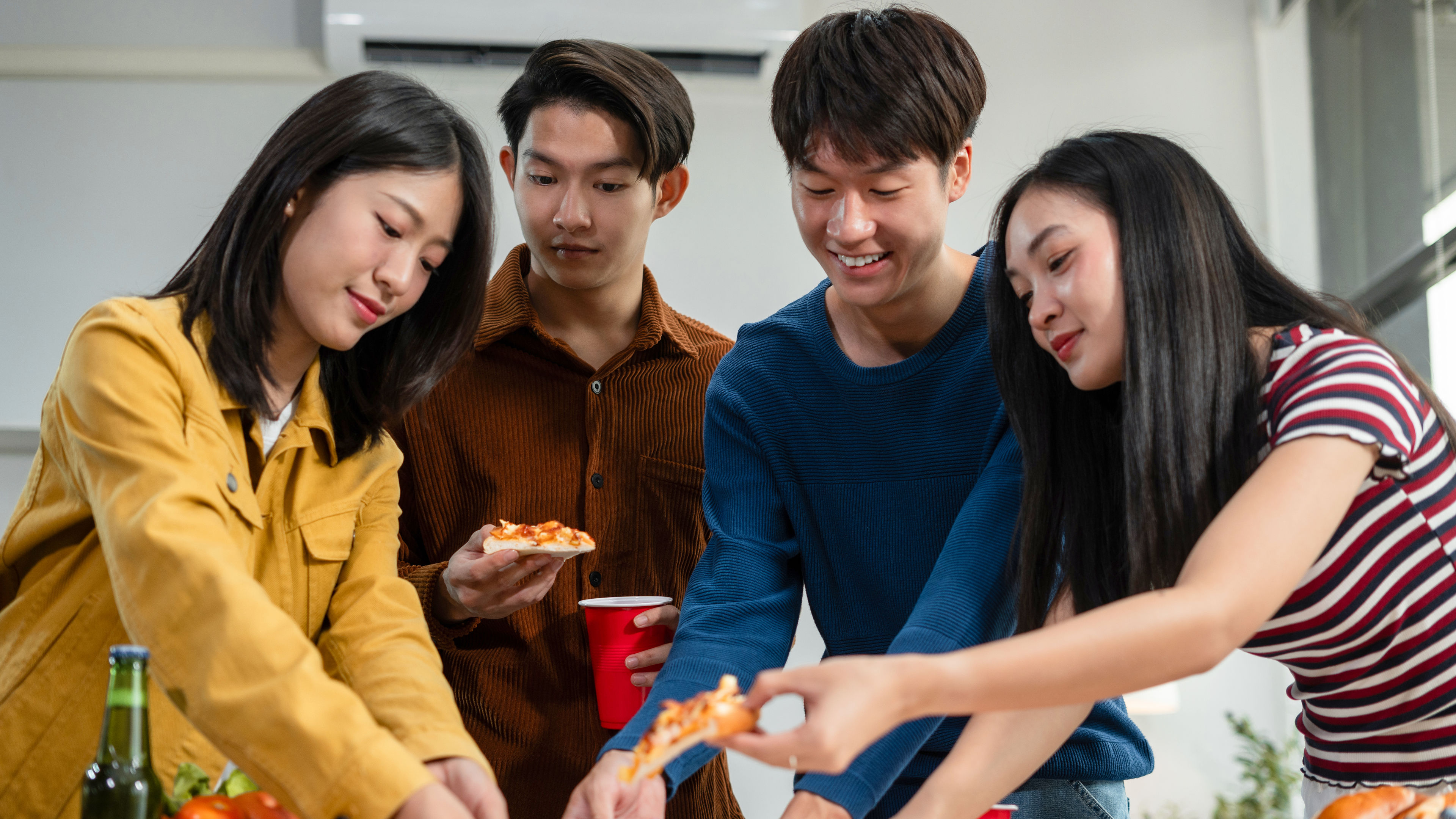 A group of friends taking Pizza