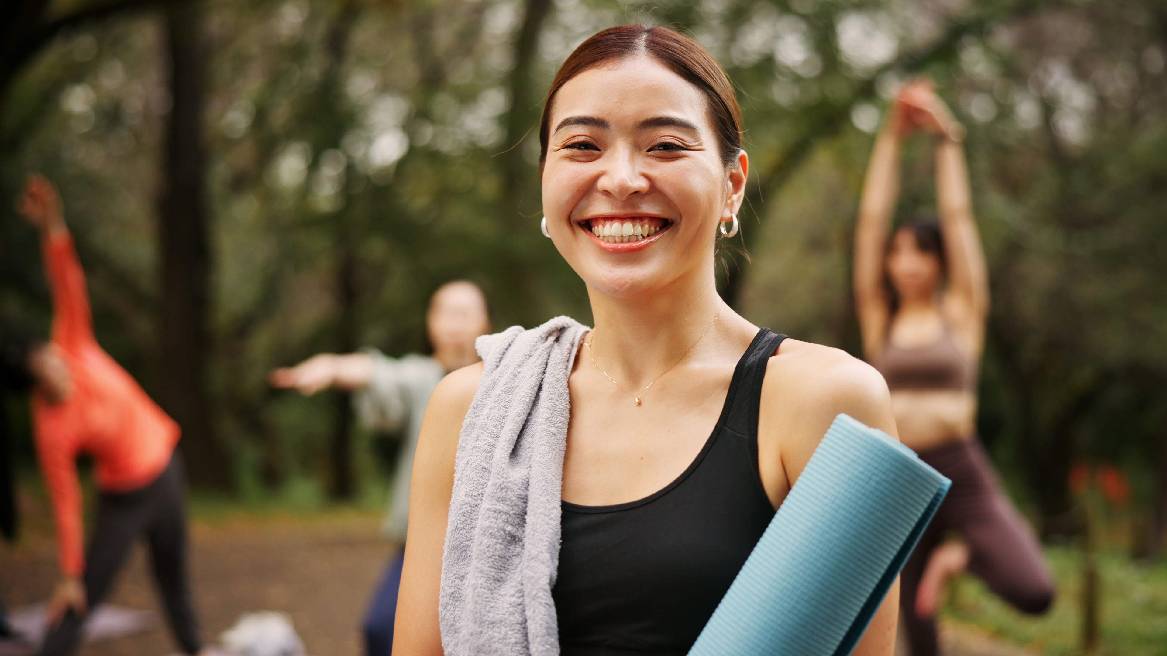 A woman with a yoga mat