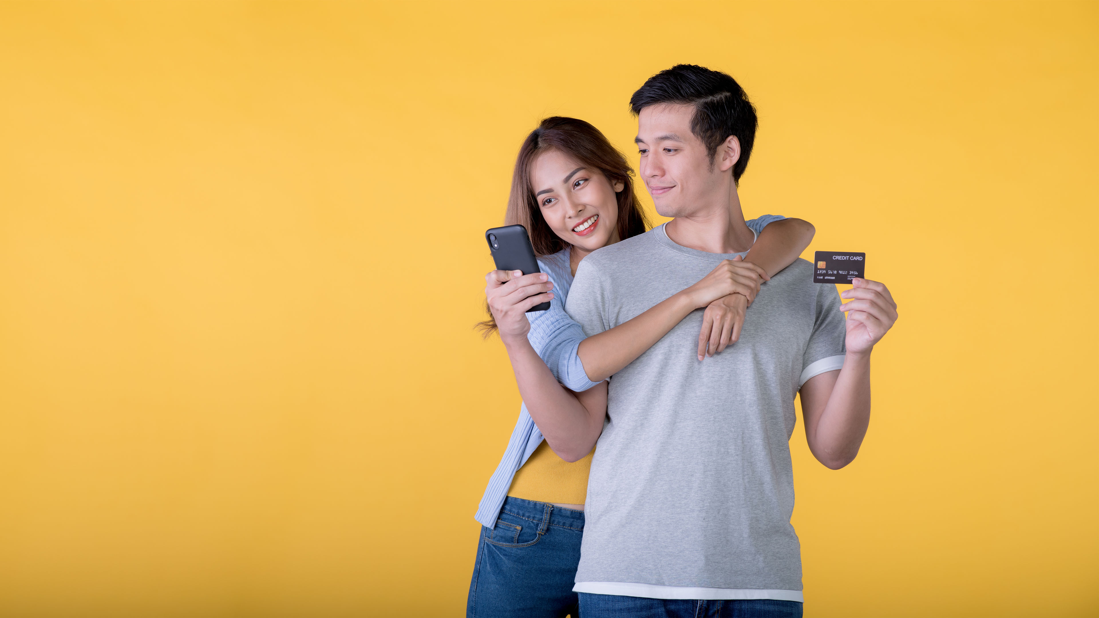 Couple Smiling Holding Phone