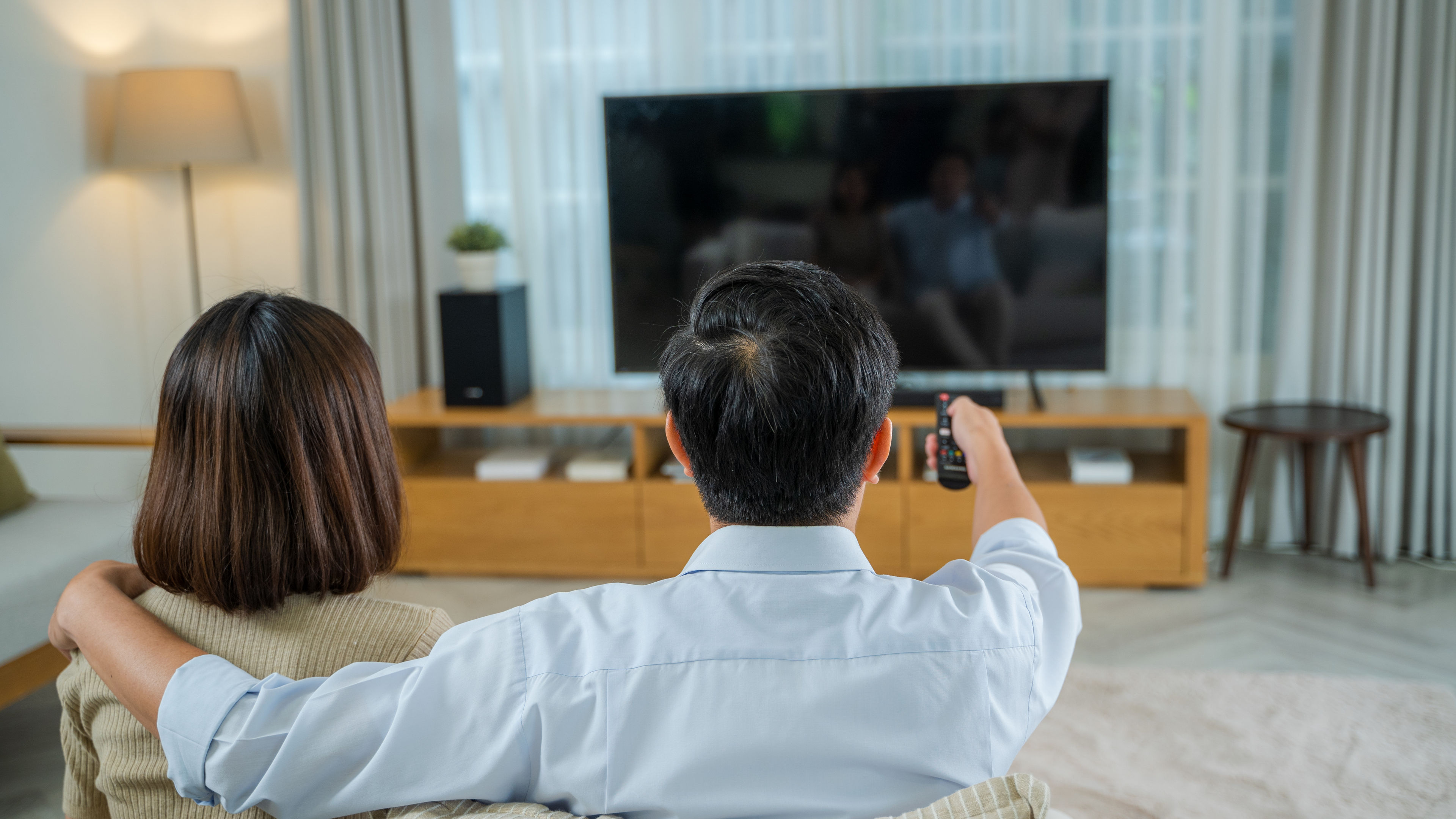 Family watching TV on couch,Using the control remote