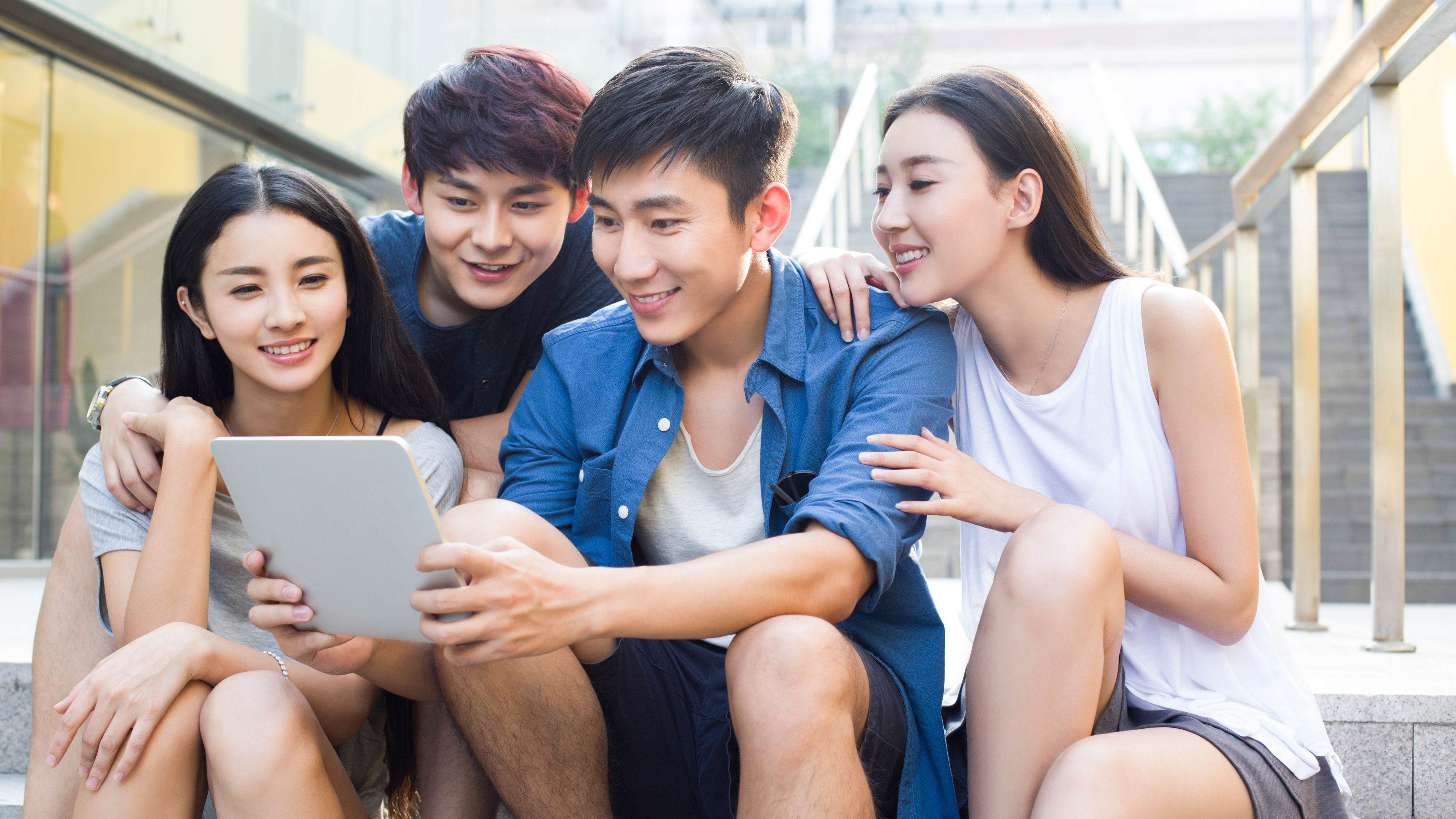 Friends looking at a tablet