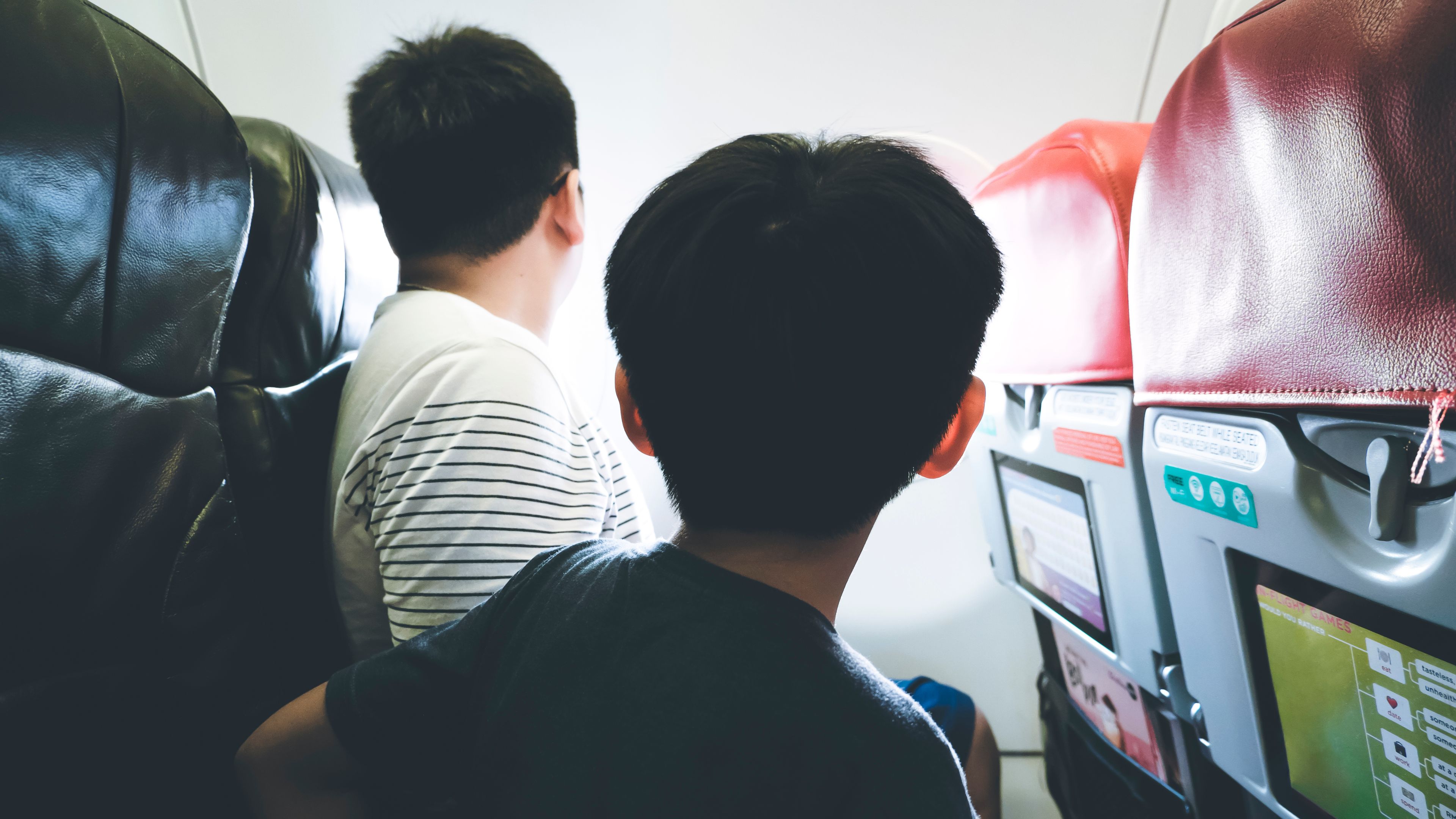 Kids Looking Out Of Airplane Window
