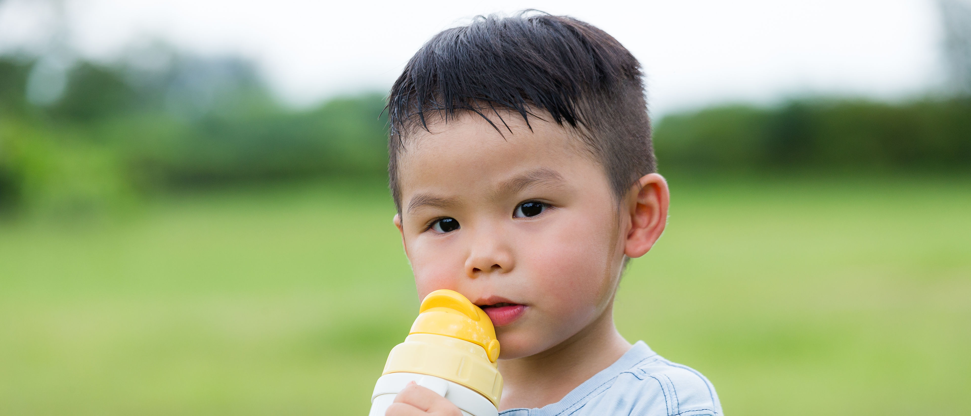 little boy drinking water 