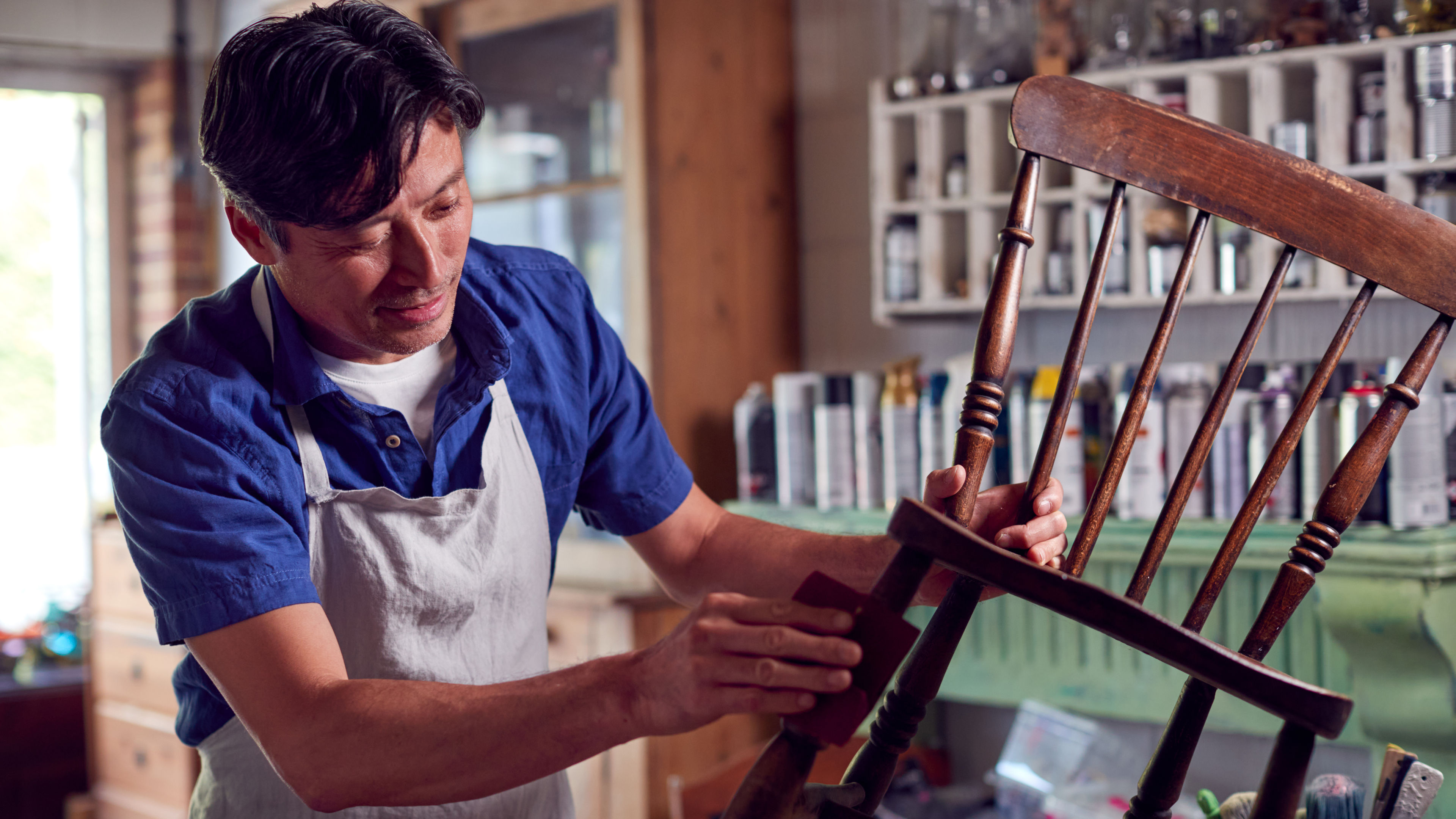 A man restoring a furniture by working on it 