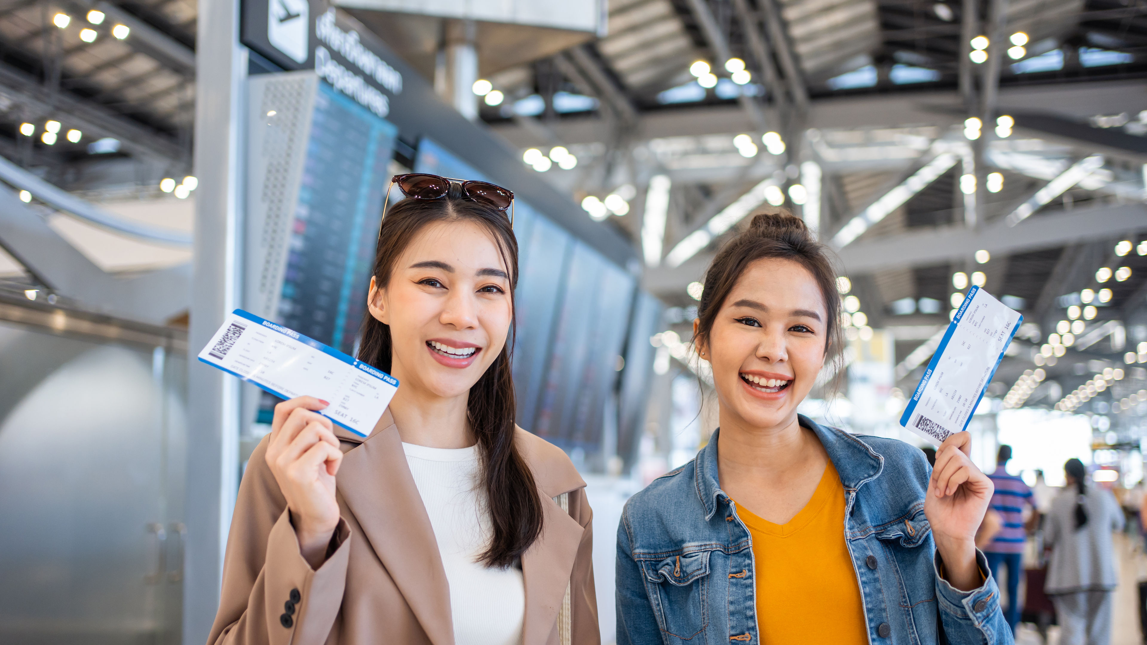 Portrait of Asian women standing in airport terminal at boarding gate