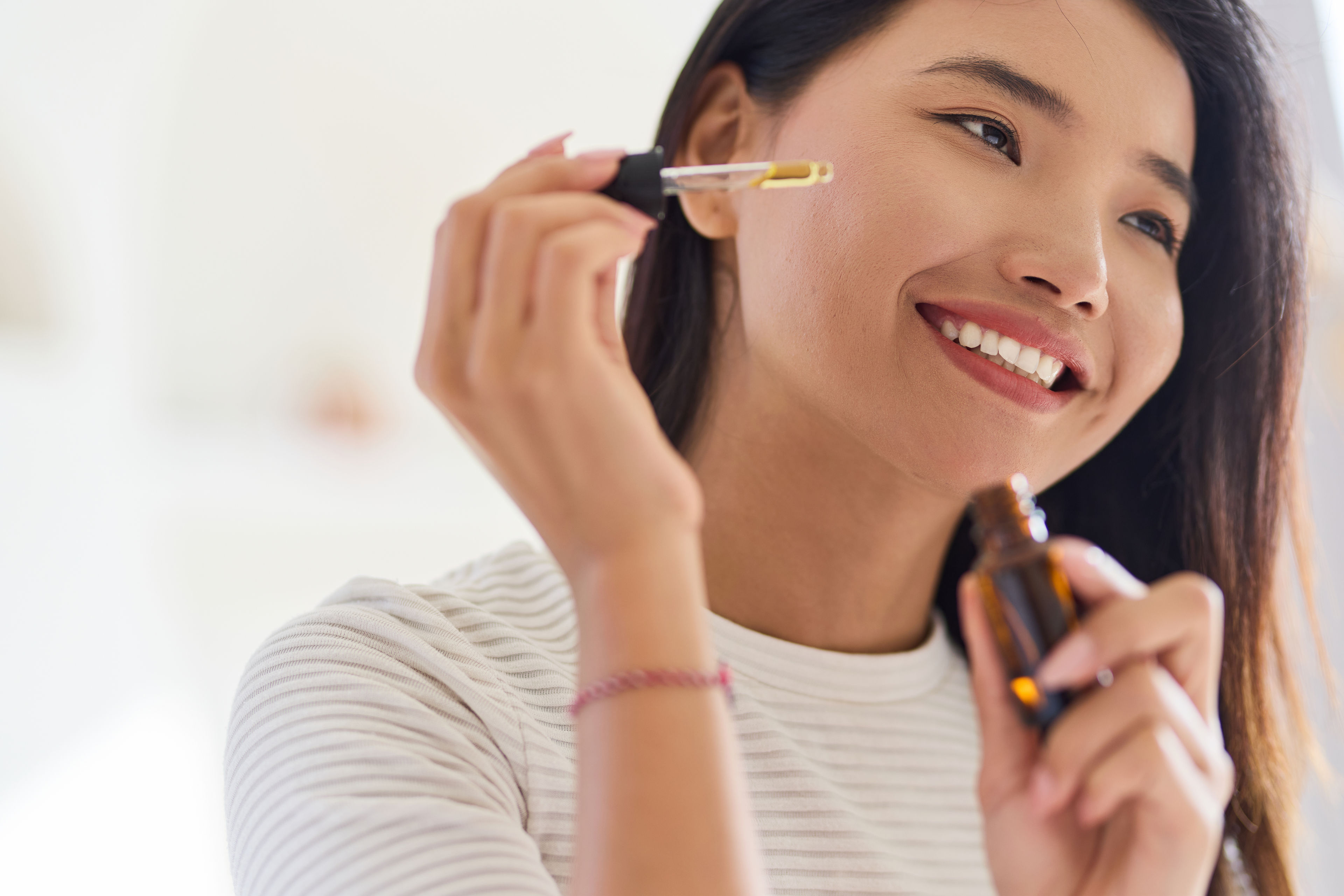 Woman applying serum