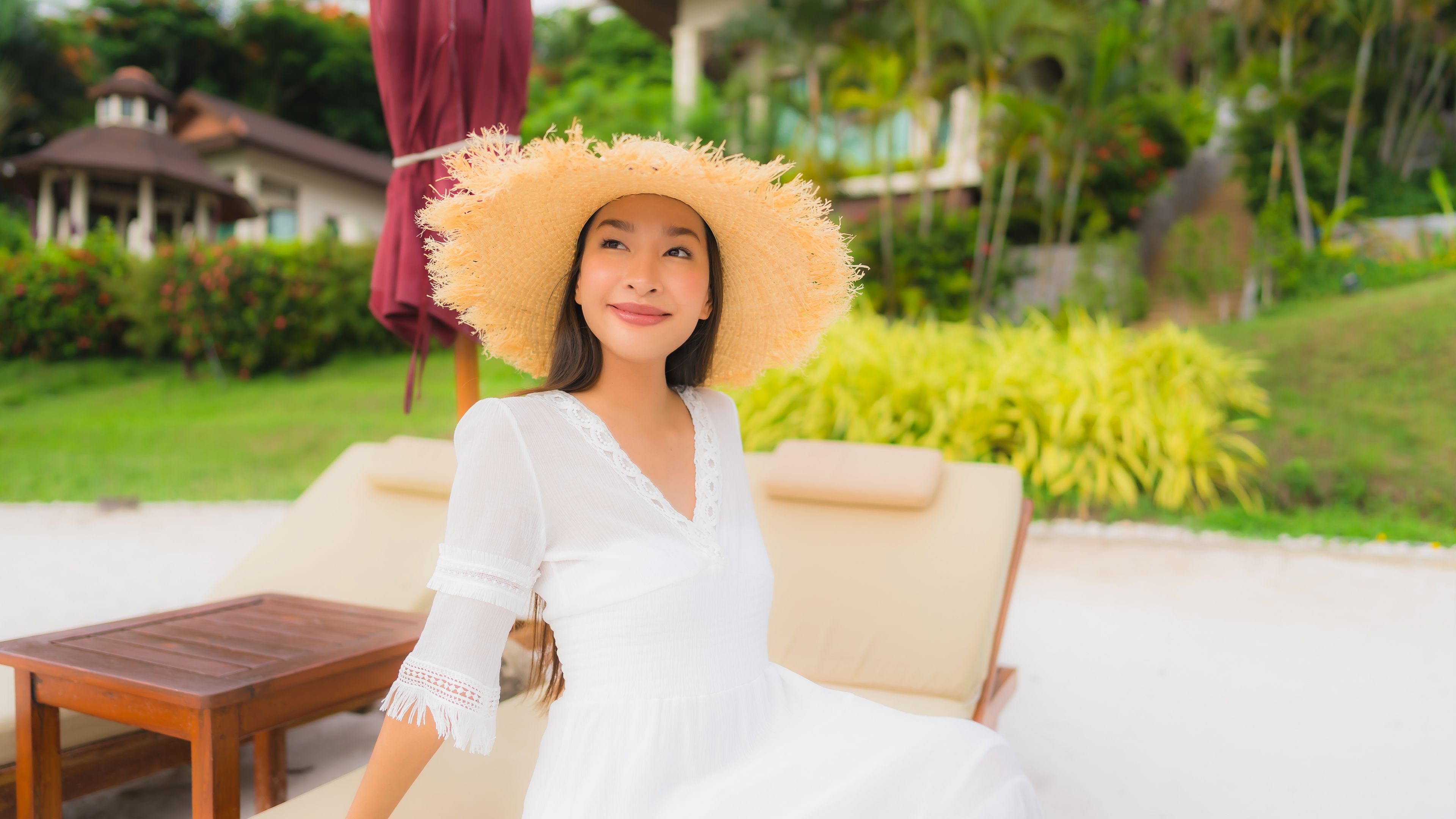 Woman in White Dress and Hat Lounging