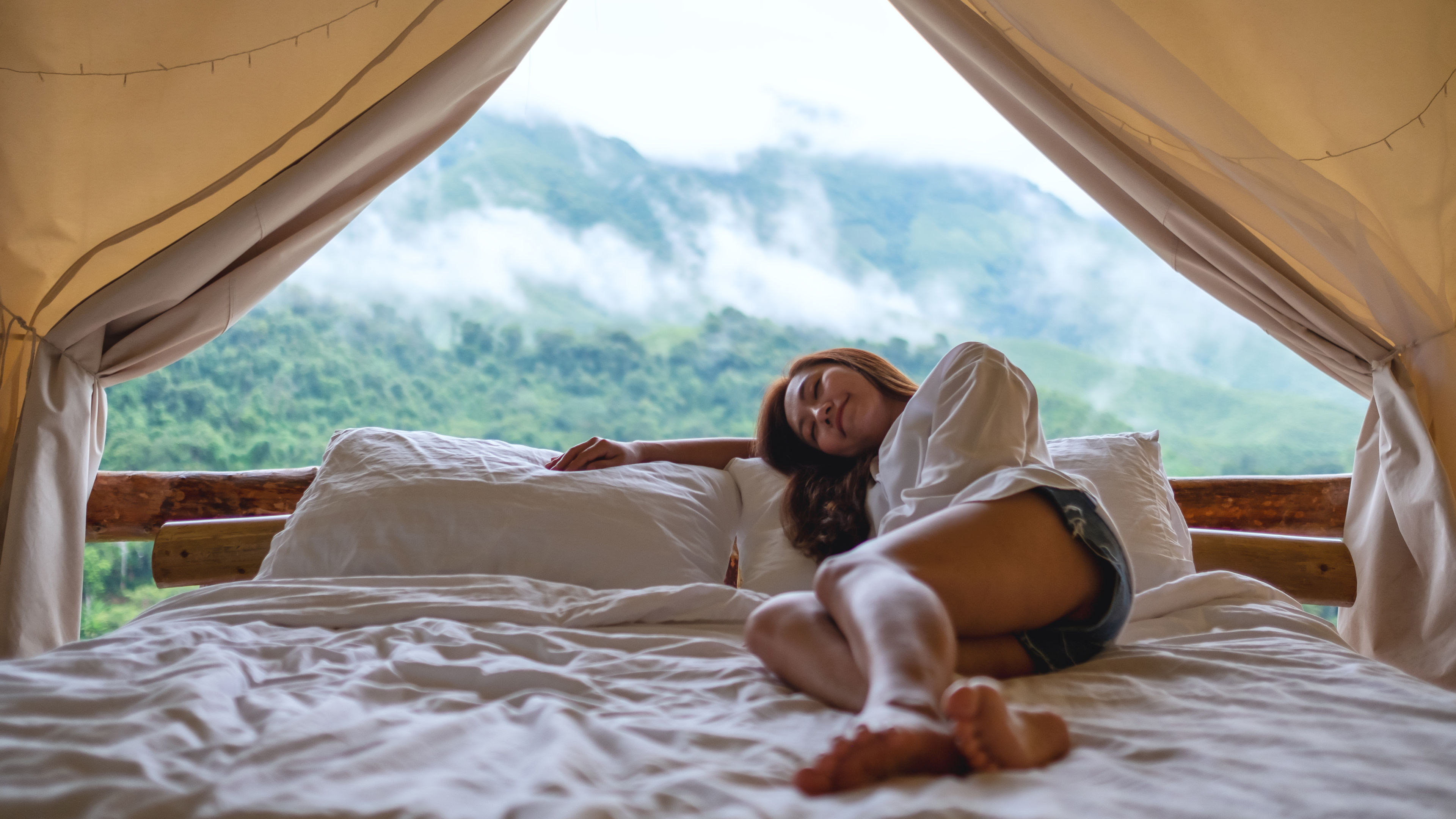 Young Woman Lying On A White Bed