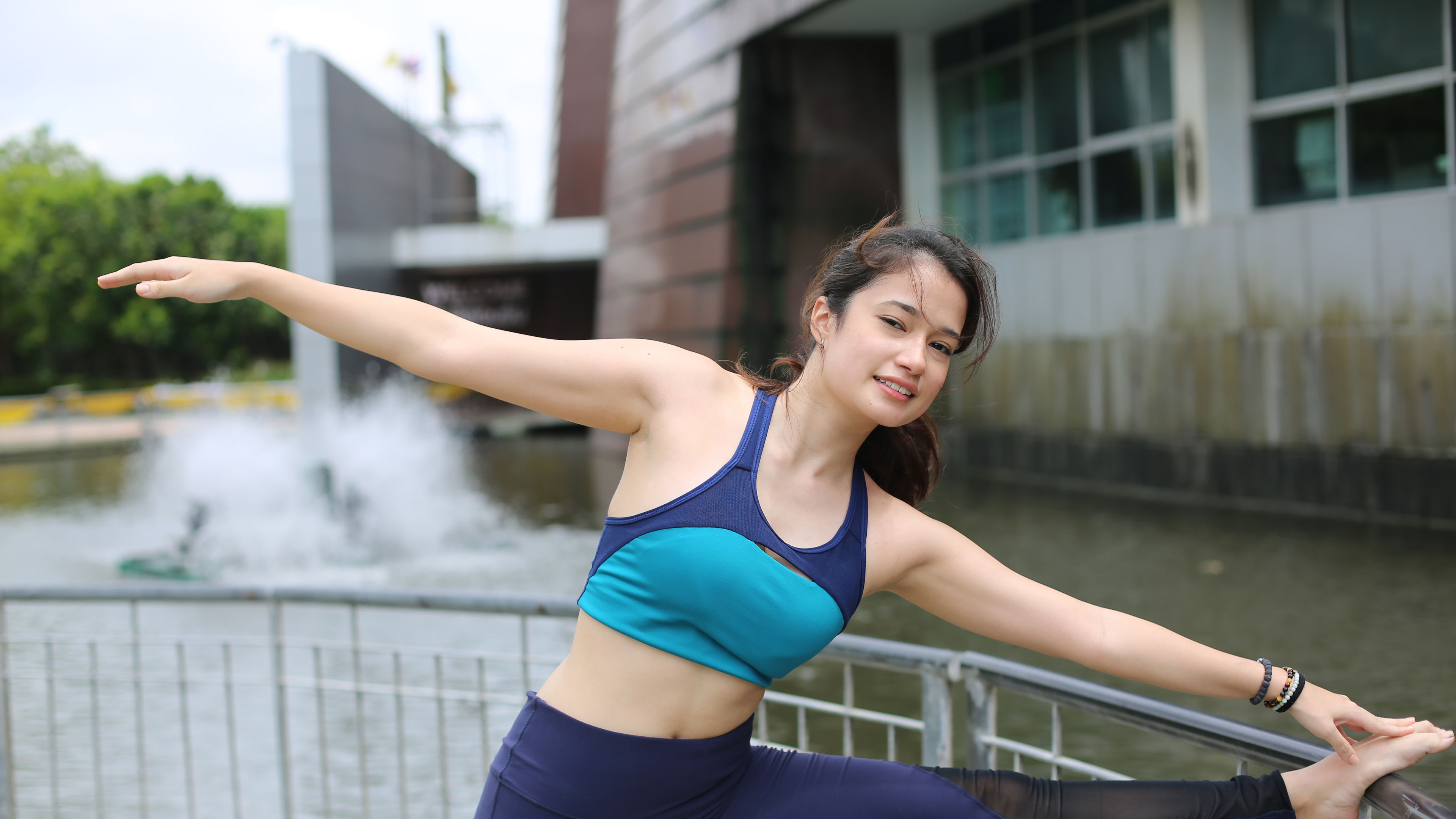 Young Woman Stretching Outdoors 